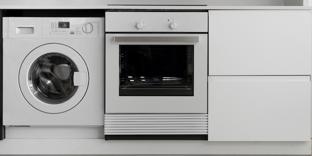 Black and white oven and washing machine in kitchen