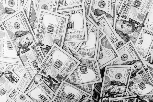 Black and white photo of 100 dollar bills Money American currency as background