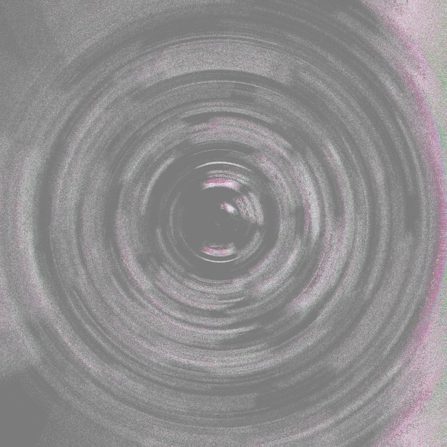 Photo a black and white photo of a circle with a pink and purple background