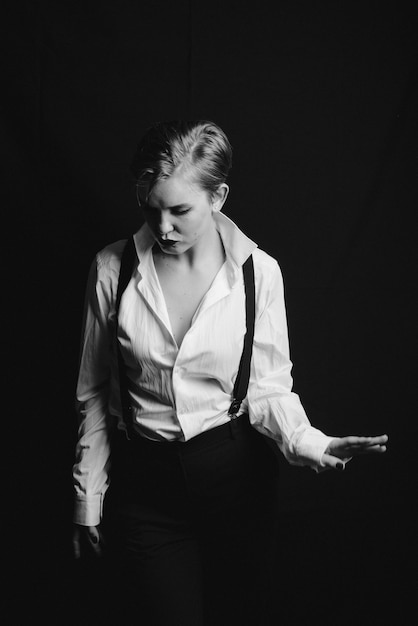 Black and white photo of a girl dancing with a hat. in the Noir style . with the thrown grain in the photo