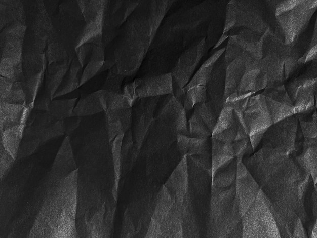 a black and white photo of a paper with a black background