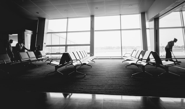 Black and white photo of rows of seats at airport terminal