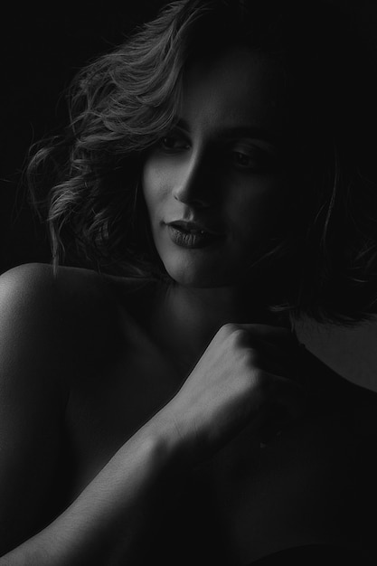 Black and white portrait of gorgeous model with naked shoulders