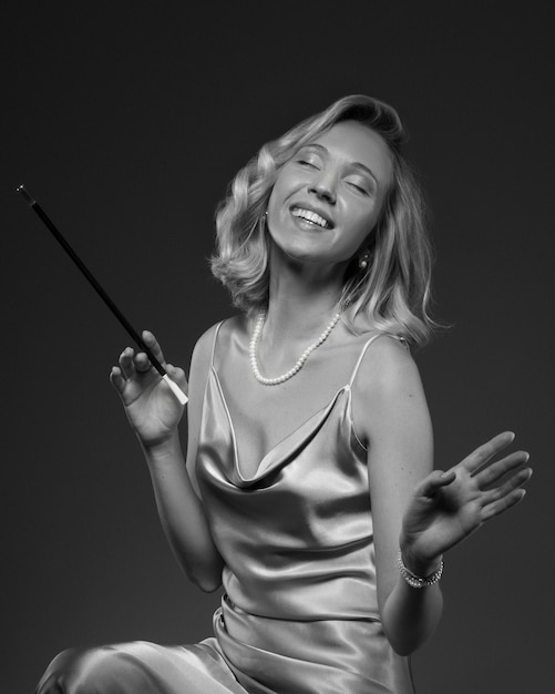 Black and white portrait of woman with cigarette in old hollywood glamour style