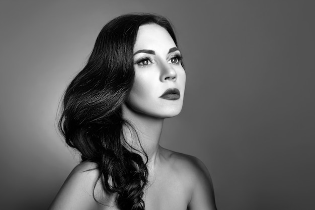 Black and white portrait of a woman with perfect clean skin close-up.