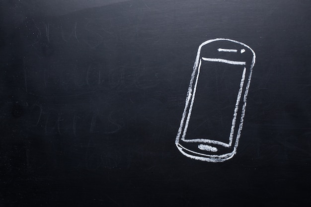 Black and white smartphone  on chalkboard