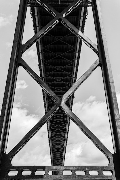 Black and white Steel Bridge close up view metal element against cloudy sky