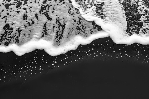 Photo black and white wave abstract ocean wave on black sand tropical beach background