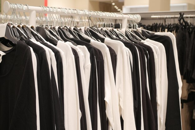 Black and white women cloths hanging on shelf display for sale