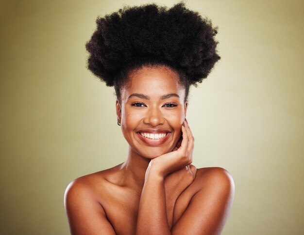 Black woman afro hair or skincare glow on studio background for natural hair promotion self love or empowerment Portrait smile or happy beauty model with makeup cosmetics on green mockup backdrop