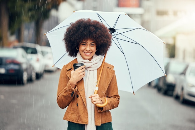 Black woman afro umbrella and smile for city travel tourism or love for rain in the street outdoors Portrait of African American female smiling in happiness for rainy day preparation in the town