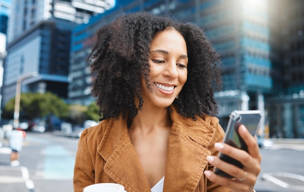 Black woman city and texting with phone smile or sunshine on outdoor adventure in summer Girl urban sidewalk or street in metro for social media app and chat with happiness holiday or travel