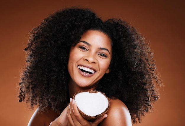 Black woman coconut and beauty cosmetics makeup or natural skincare wellness Luxury skin nutrition healthy facial glow and self care afro and natural or organic hair care health in studio