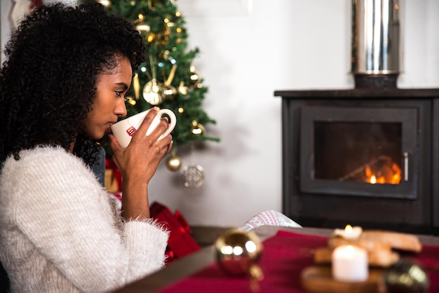 Black woman drinking hot beverage