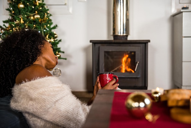 Black woman drinking hot beverage