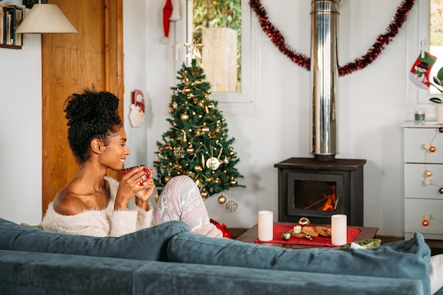 Black woman drinking hot beverage