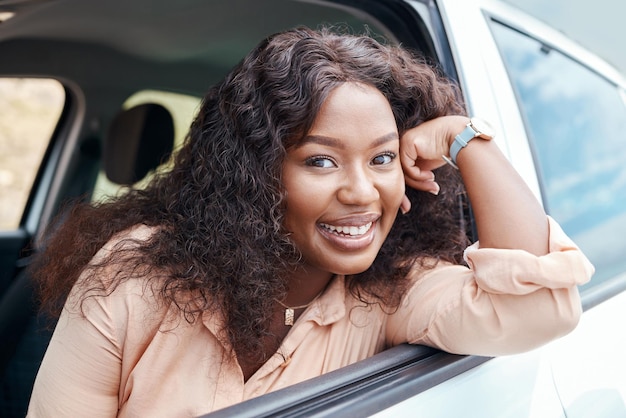 Black woman happy and smile at window of car on road trip travel or vacation Portrait woman and driver with happiness in transport on road street or drive in sunshine outdoor in Cape Town