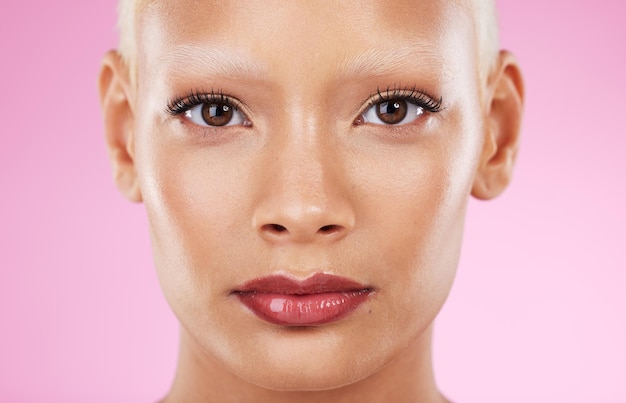 Black woman portrait and beauty cosmetics of a young model with makeup and skincare Isolated pink background and studio with a female feeling calm from spa wellness dermatology and face skin glow