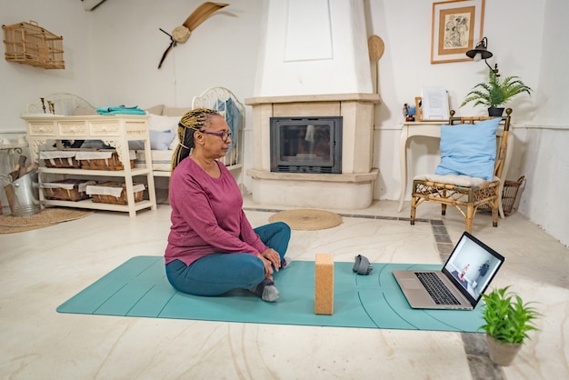 A black woman practices crying at home online with her laptop