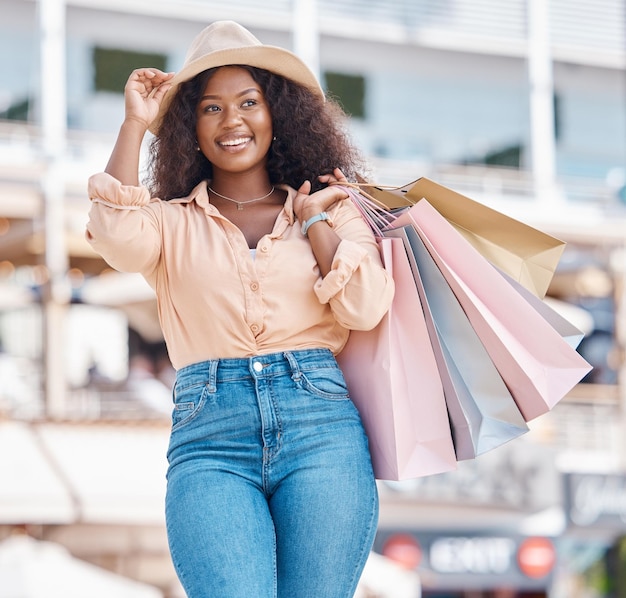 Black woman retail shopping bag and city travel for discount sales summer market and fashion promotion in San Francisco California Happy wealthy and freedom of fun young girl spending on vacation