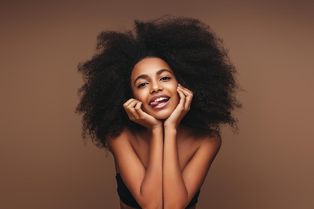 Black woman skincare and cosmetics skin wellness model with happy smile facial cosmetic health and natural glow Luxury spa healthcare afro hair care and studio mockup for beauty self care product