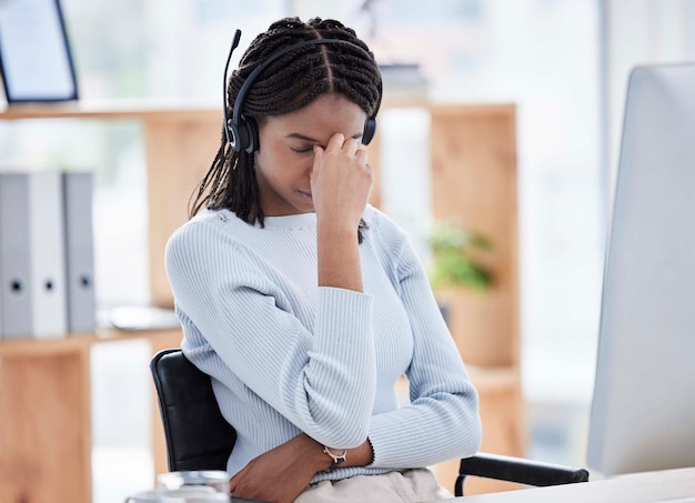 Black woman stress or headache on call center computer in telemarketing company b2b sales business or contact us startup Receptionist customer support or consultant anxiety on technology burnout