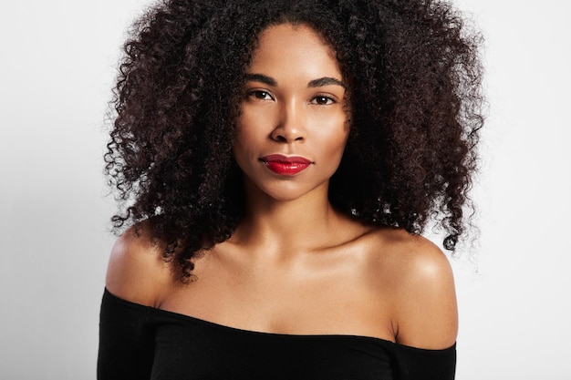 Black woman watching at camera directly curly hair