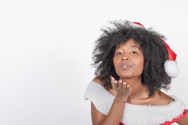 Black woman wishing merry christmas blowing with her hand