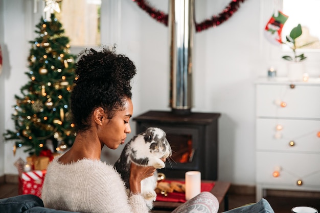 Black woman with rabbit on Christmas