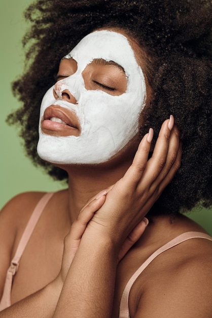 Black woman with white clay mask