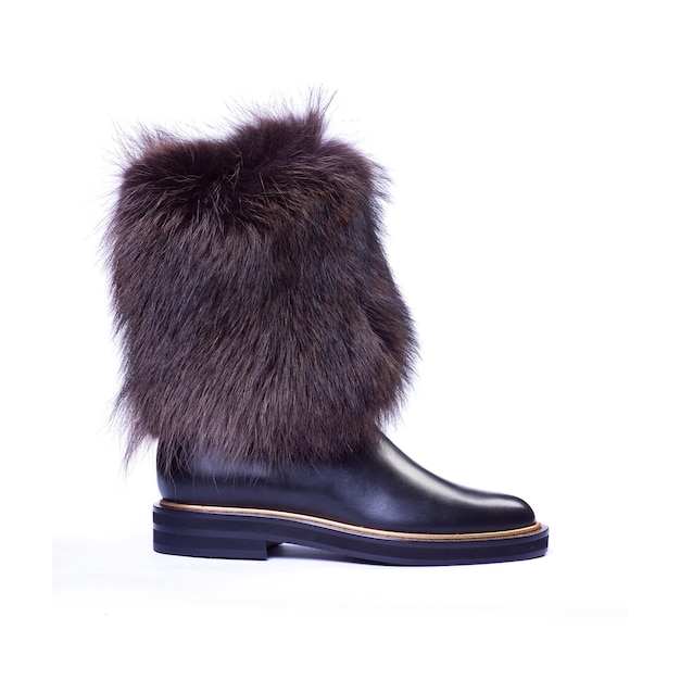 Black womens boot with fur on a neutral white background