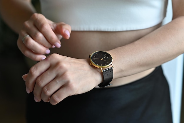 Black womens wrist watch on the girls hand