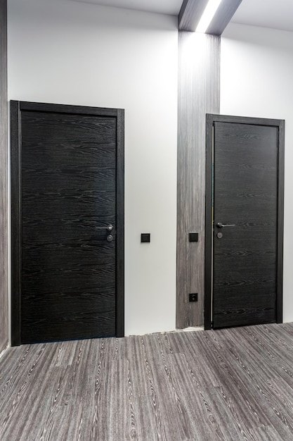 Black wooden door in dark style color for modern interior and apartments flat or office