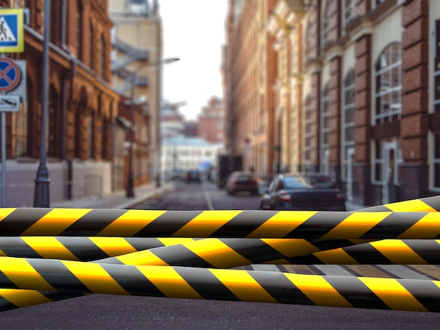 A black and yellow safety tape outdoors in the street restricted area