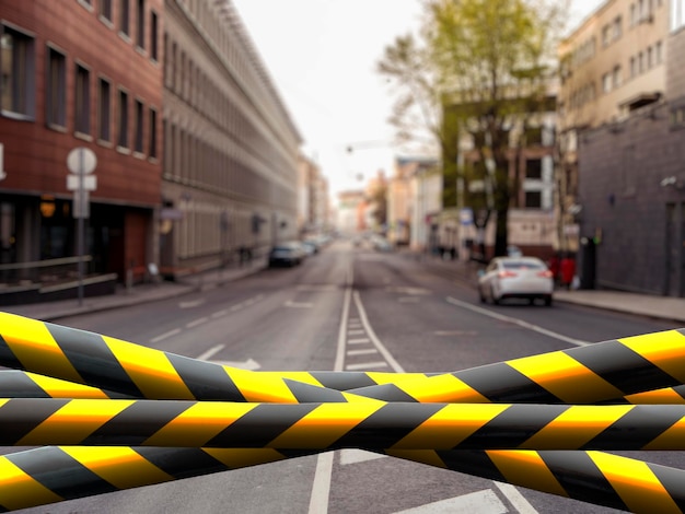 A black and yellow safety tape outdoors in the street restricted area