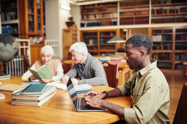 Black Young Man Studying in Library