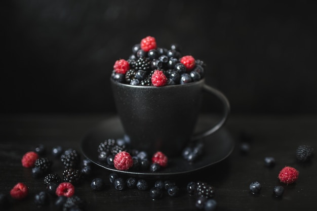 Blackberries, blueberries, raspberries, fresh berries, black background, vegetarian food