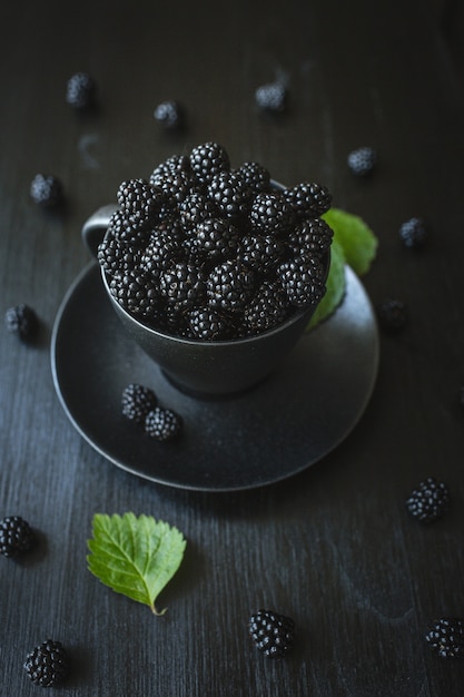 Blackberries, fresh berries, black background, vegetarian food