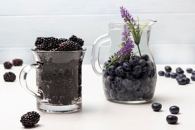 Blackberry and blueberry infused water in glass mugs