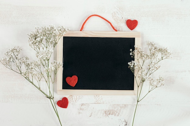 Blackboard with hearts and flowers