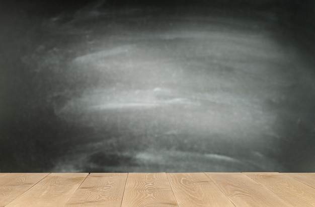 Blackboard and wooden table with copy space