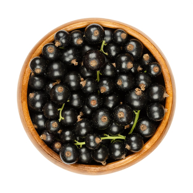 Blackcurrant berries in a wooden bowl