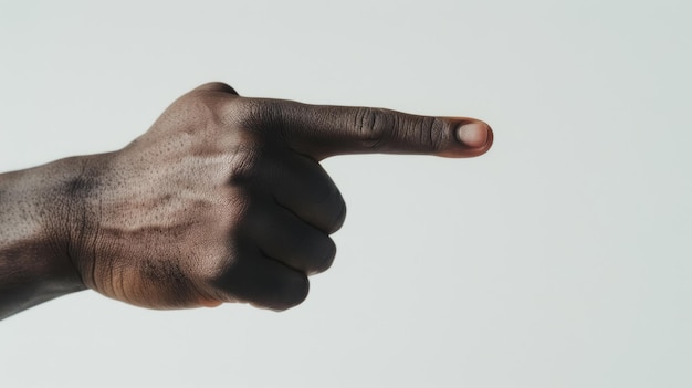 A blackskinned male hand pointing its index finger forward against a white background