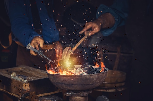 blacksmith make a horseshoe.