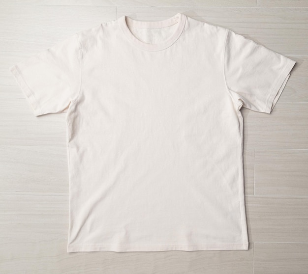 Photo blank beige tshirt mockup template on the floor