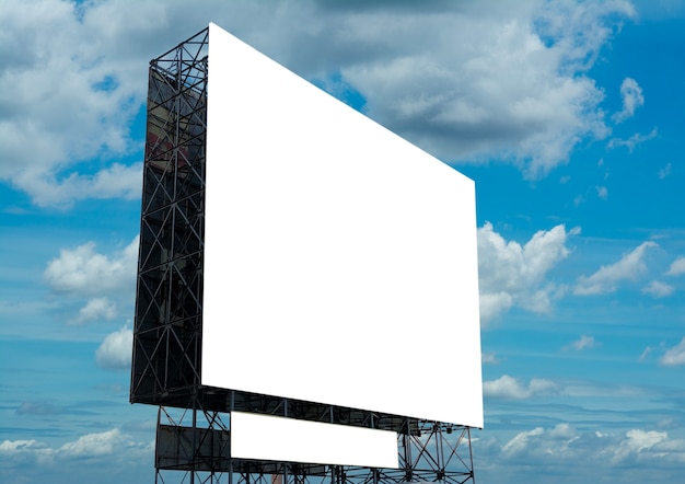 Blank billboard against the blue cloudy sky