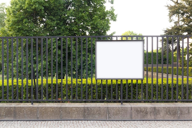 Blank billboard mock up in a public garden