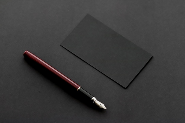 Blank black business card for mockup and pen on dark background luxury branding and corporate identi...