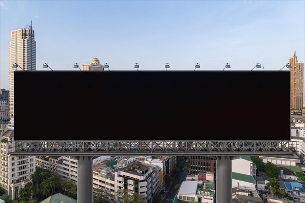 Blank black road billboard with Bangkok cityscape background at day time Street advertising poster mock up 3D rendering Front view The concept of marketing communication to promote or sell idea