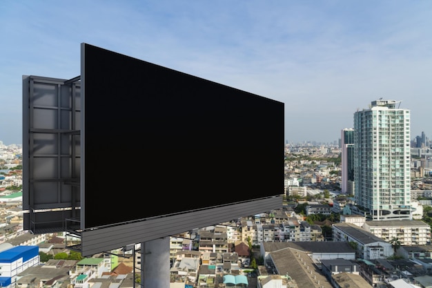 Blank black road billboard with Bangkok cityscape background at day time Street advertising poster mock up 3D rendering Side view The concept of marketing communication to promote or sell idea